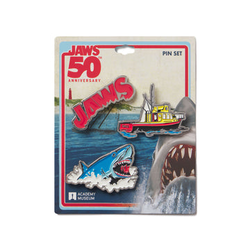 Packaged Jaws 50th Anniversary pin set with shark, boat, and lighthouse design.